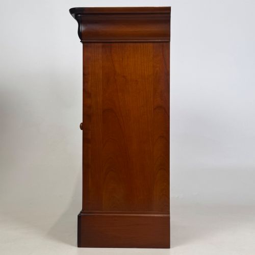 fig 4. A matching pair of 20th-century mahogany bedside cabinets featuring single panelled doors, turned wooden handles, moulded cornices, and solid plinth bases.