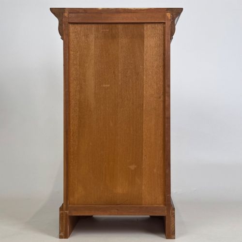 fig 6. A matching pair of 20th-century mahogany bedside cabinets featuring single panelled doors, turned wooden handles, moulded cornices, and solid plinth bases.