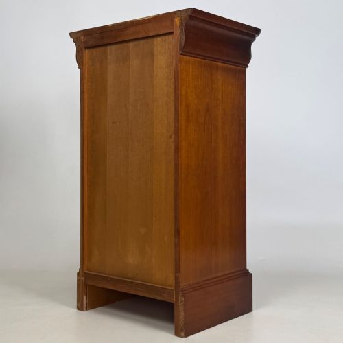 fig 7. A matching pair of 20th-century mahogany bedside cabinets featuring single panelled doors, turned wooden handles, moulded cornices, and solid plinth bases.