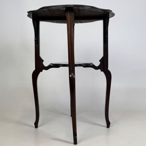 fig 1. An Edwardian dark mahogany side table featuring a shaped top, pierced carved spandrels, slender cabriole legs, and a lower tier shelf.
