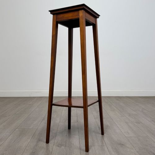 fig 1. A tall, slender Edwardian satinwood plant stand with square tapered legs, a flat square top, and a lower undertier shelf.