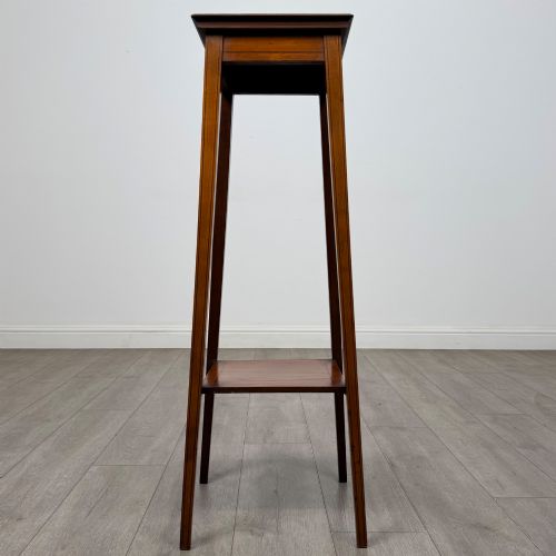 fig 2. A tall, slender Edwardian satinwood plant stand with square tapered legs, a flat square top, and a lower undertier shelf.