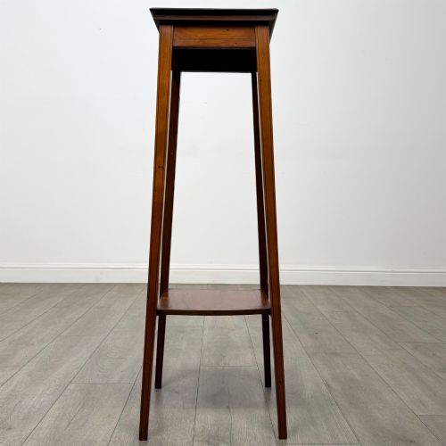 fig 4. A tall, slender Edwardian satinwood plant stand with square tapered legs, a flat square top, and a lower undertier shelf.