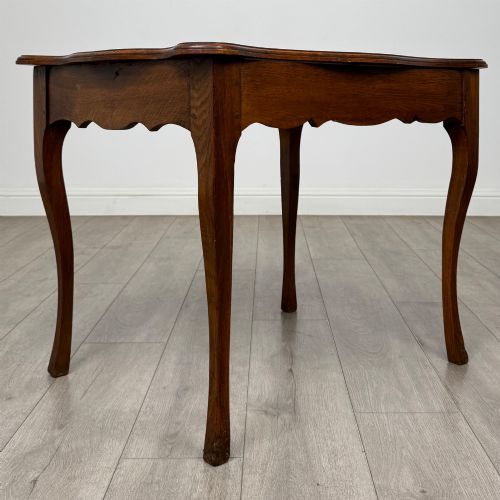 fig 3. A French provincial oak side table with curved cabriole legs and a scalloped apron.