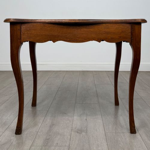 fig 4. A French provincial oak side table with curved cabriole legs and a scalloped apron.