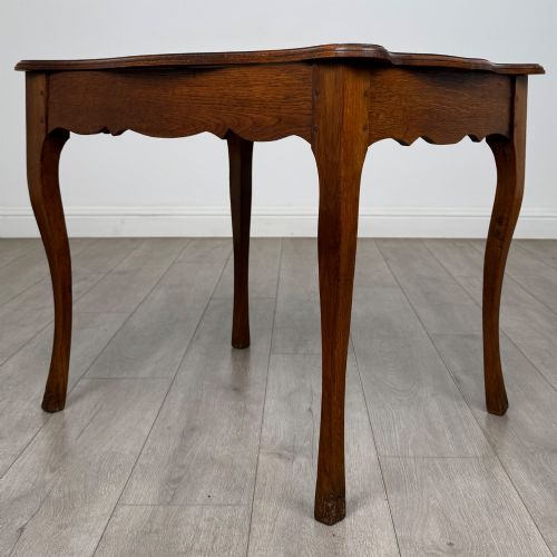 fig 5. A French provincial oak side table with curved cabriole legs and a scalloped apron.