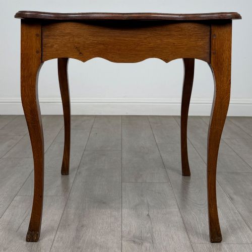 fig 6. A French provincial oak side table with curved cabriole legs and a scalloped apron.