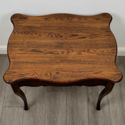 fig 8. A French provincial oak side table with curved cabriole legs and a scalloped apron.