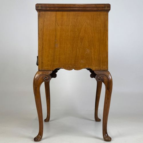 fig 2. An Edwardian burr walnut cabinet resting on slender cabriole legs with ornate brass drop handles.
