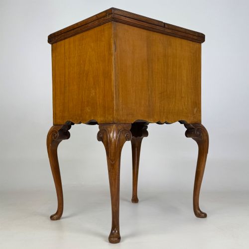 fig 3. An Edwardian burr walnut cabinet resting on slender cabriole legs with ornate brass drop handles.