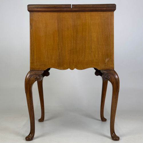 fig 4. An Edwardian burr walnut cabinet resting on slender cabriole legs with ornate brass drop handles.