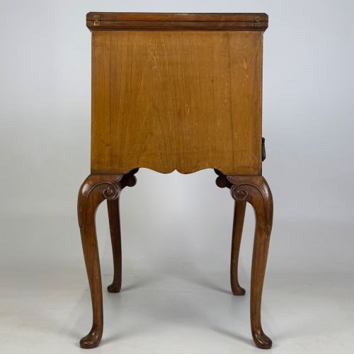 fig 6. An Edwardian burr walnut cabinet resting on slender cabriole legs with ornate brass drop handles.