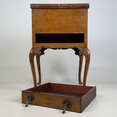fig 8. An Edwardian burr walnut cabinet resting on slender cabriole legs with ornate brass drop handles.