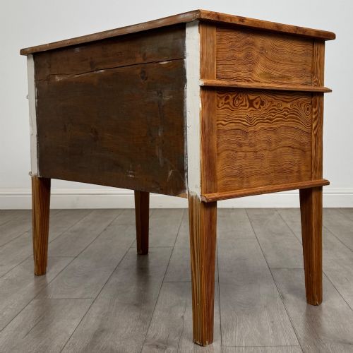 fig 6. A Victorian pitch pine cupboard featuring a single top drawer over two cupboard doors with diagonal timber panels and straight tapered legs.