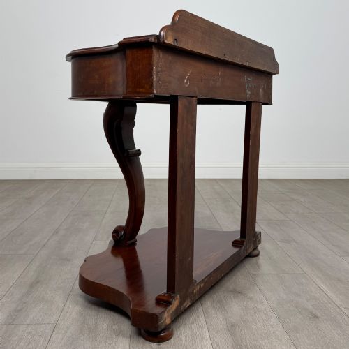 fig 3. A 19th-century Victorian mahogany washstand featuring a carved central leg, shaped top, and contoured plinth base.