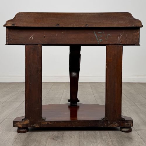 fig 4. A 19th-century Victorian mahogany washstand featuring a carved central leg, shaped top, and contoured plinth base.