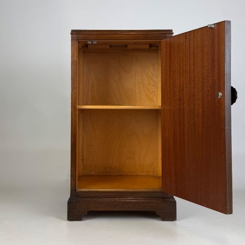 fig 1. A standing antique dark oak bedside cabinet with a single framed door, a round carved handle, and a solid plinth base.