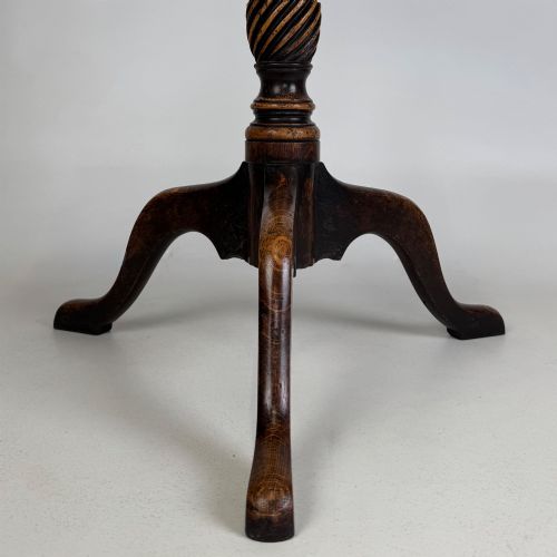 fig 3. A 19th-century dark oak circular side table featuring a turned pedestal with spiral carving on a tripod base.