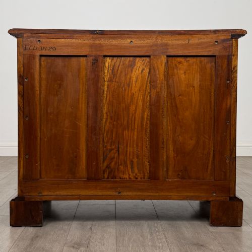 fig 4. A 20th-century Georgian style mahogany chest featuring four full-width drawers with brass drop handles, flanked by ebonised side columns, resting on bracket feet.
