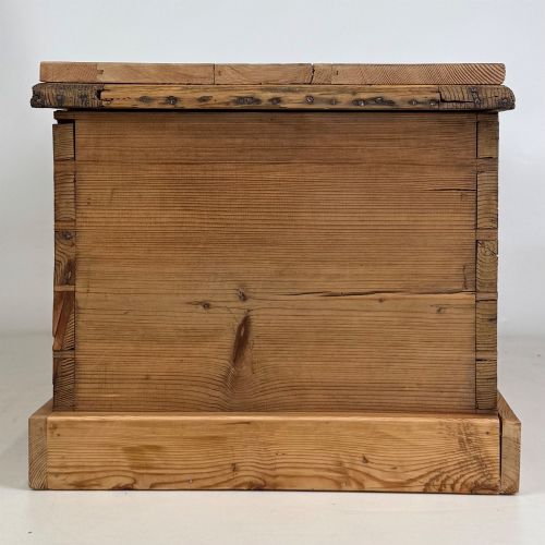 fig 6. A nineteenth-century Victorian pine blanket box featuring a flat hinged lid, central iron keyhole escutcheon, visible corner joinery, and a solid plinth base.