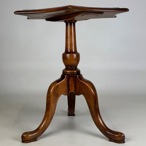 fig 2. A walnut tripod side table featuring a baluster-turned central pedestal, three splayed cabriole legs, and a shaped top.