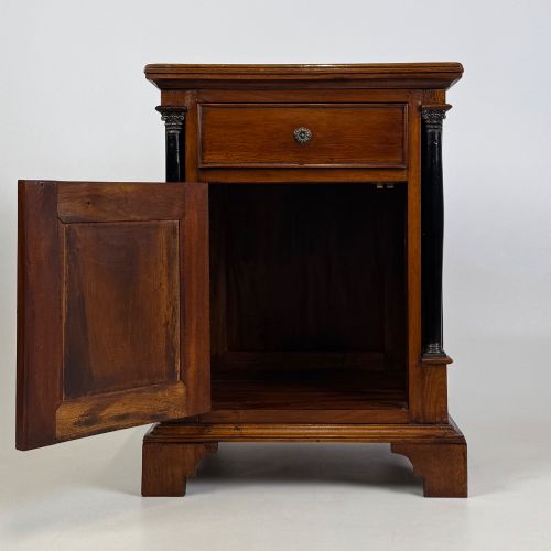 fig 2. A pair of matching mahogany bedside cabinets with single top drawers, panelled cupboard doors, and black ebonised side columns.