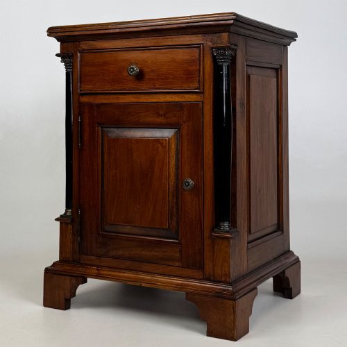 fig 3. A pair of matching mahogany bedside cabinets with single top drawers, panelled cupboard doors, and black ebonised side columns.