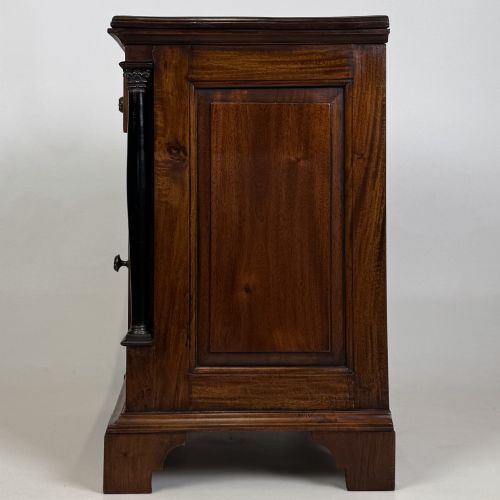 fig 4. A pair of matching mahogany bedside cabinets with single top drawers, panelled cupboard doors, and black ebonised side columns.