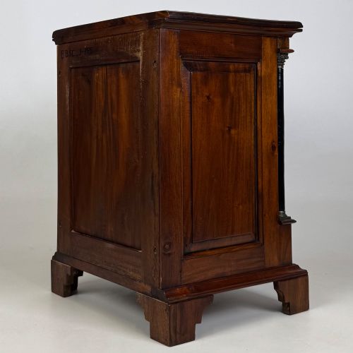 fig 7. A pair of matching mahogany bedside cabinets with single top drawers, panelled cupboard doors, and black ebonised side columns.