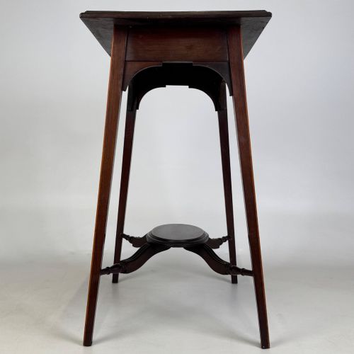fig 6. An Edwardian mahogany side table featuring a square top, splayed legs, corner spandrels, and a central circular undertier supported by shaped stretchers.