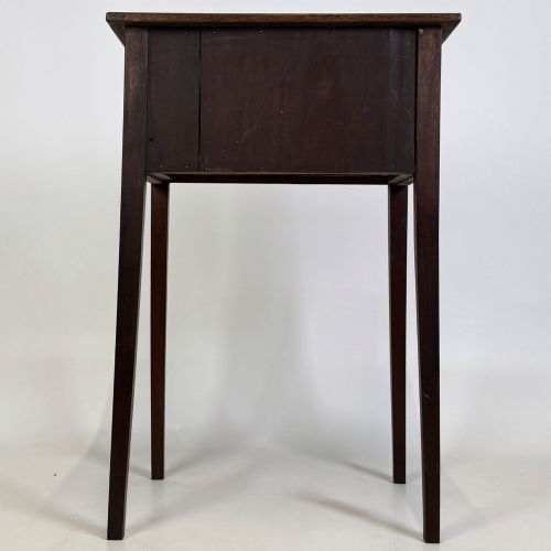fig 4. An antique dark mahogany side table featuring two stacked drawers with circular handles, supported by tall tapered square legs.