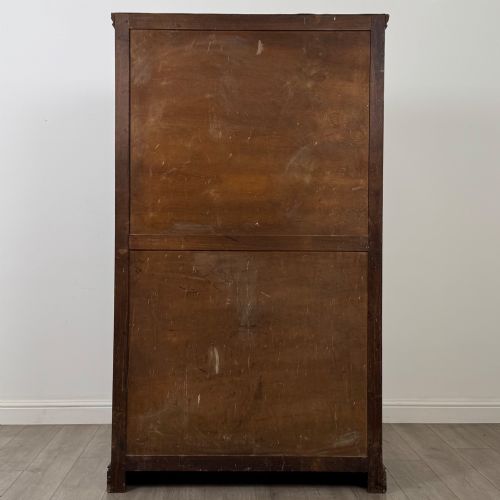 fig 5. A tall dark oak Edwardian two-door wardrobe featuring carved diamond panel details and decorative iron hinges.