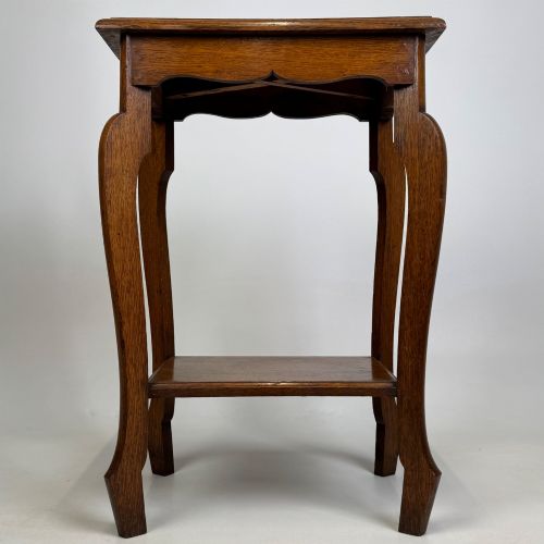 fig 4. An Edwardian oak side table featuring a rectangular top, shaped apron, flared legs, and a lower square tier.