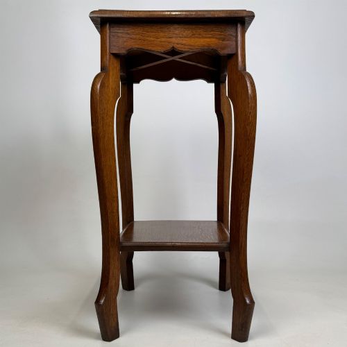fig 6. An Edwardian oak side table featuring a rectangular top, shaped apron, flared legs, and a lower square tier.