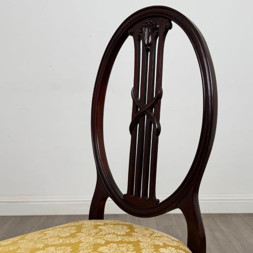 fig 3. A set of four dark mahogany dining chairs with carved oval backs, slender vertical splats, and gold damask upholstered seats.