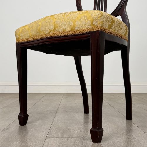 fig 4. A set of four dark mahogany dining chairs with carved oval backs, slender vertical splats, and gold damask upholstered seats.