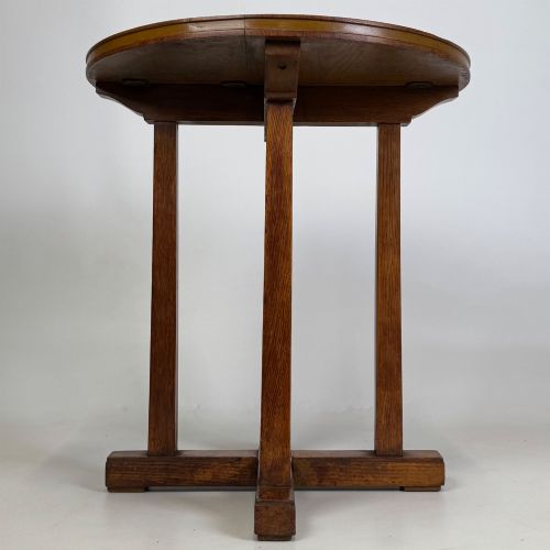 fig 2. An early twentieth-century round oak side table featuring a circular top supported by straight legs and an X-frame cross base.