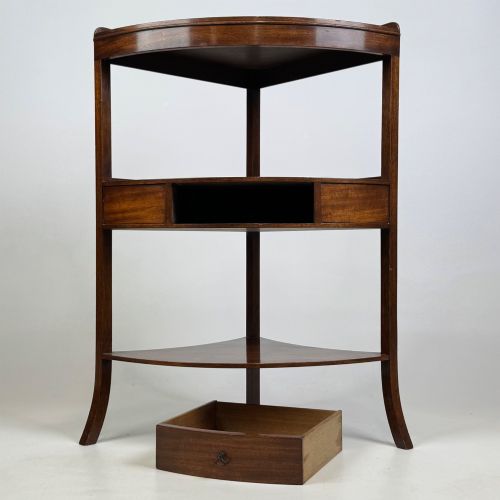 fig 5. A three-tiered Georgian style mahogany corner stand featuring a curved front, single drawer with brass ring pull, and splayed legs.