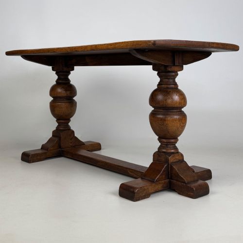 fig 1. A small 20th-century solid oak coffee table featuring heavy bulbous turned baluster legs connected by a low stretcher base.