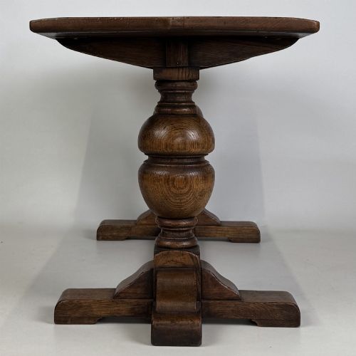 fig 2. A small 20th-century solid oak coffee table featuring heavy bulbous turned baluster legs connected by a low stretcher base.