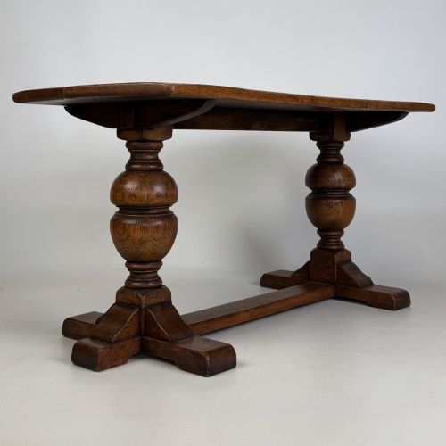fig 3. A small 20th-century solid oak coffee table featuring heavy bulbous turned baluster legs connected by a low stretcher base.