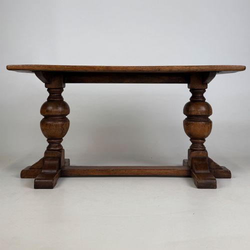 fig 4. A small 20th-century solid oak coffee table featuring heavy bulbous turned baluster legs connected by a low stretcher base.