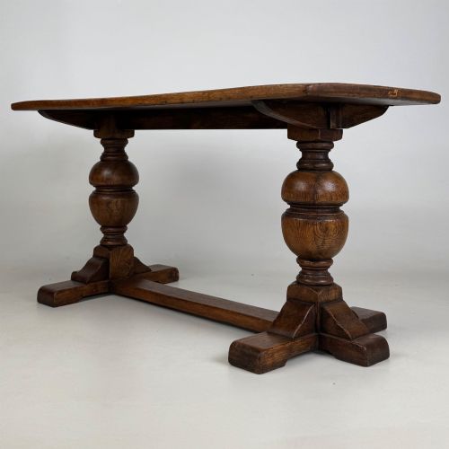 fig 5. A small 20th-century solid oak coffee table featuring heavy bulbous turned baluster legs connected by a low stretcher base.
