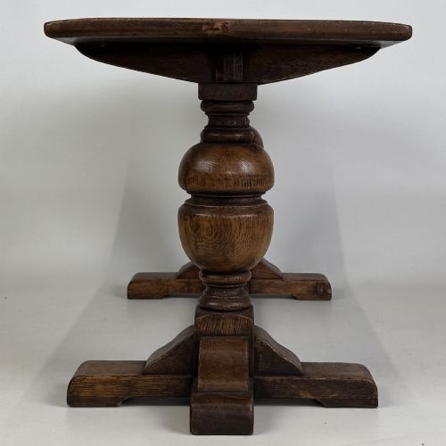 fig 6. A small 20th-century solid oak coffee table featuring heavy bulbous turned baluster legs connected by a low stretcher base.