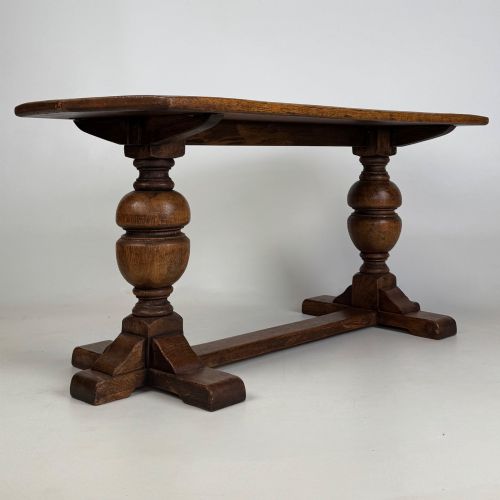 fig 7. A small 20th-century solid oak coffee table featuring heavy bulbous turned baluster legs connected by a low stretcher base.