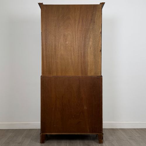fig 6. An antique mahogany bureau bookcase featuring two astragal glazed glass upper doors above a lower drop-front writing slope and four drawers.