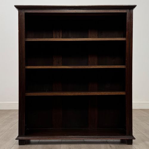 fig 1. An Edwardian open oak bookcase with four wide shelves and dark timber finish.