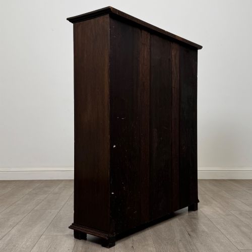 fig 4. An Edwardian open oak bookcase with four wide shelves and dark timber finish.