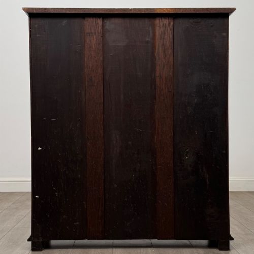 fig 5. An Edwardian open oak bookcase with four wide shelves and dark timber finish.