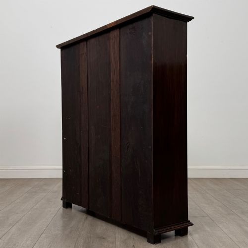 fig 6. An Edwardian open oak bookcase with four wide shelves and dark timber finish.